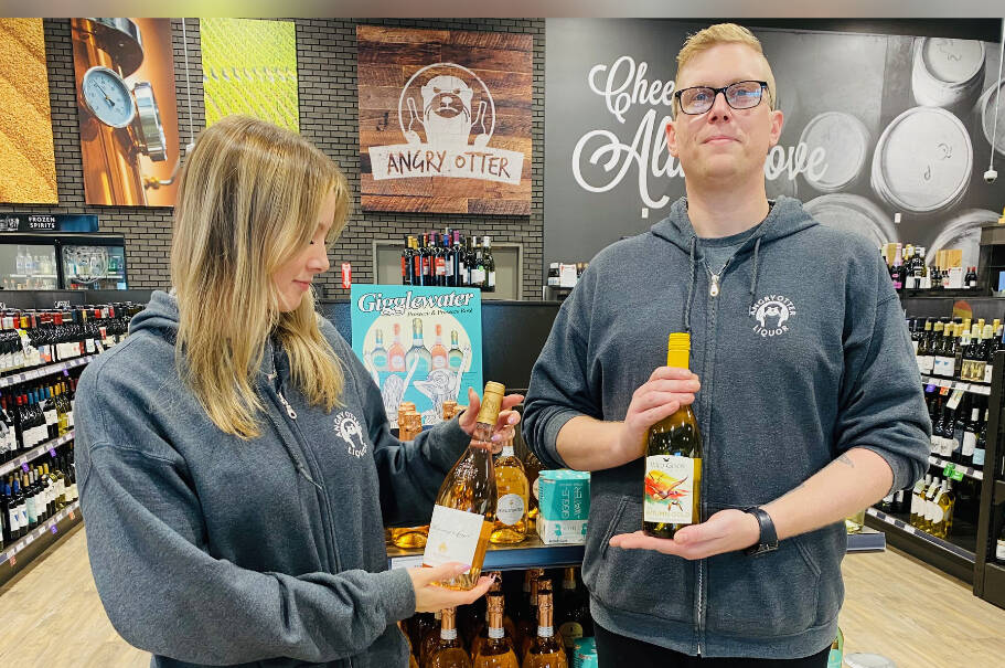 Alicen(left) and Tom(right) from 248th Angry Otter Liquor store show off some of the hottest wines this Thanksgiving.