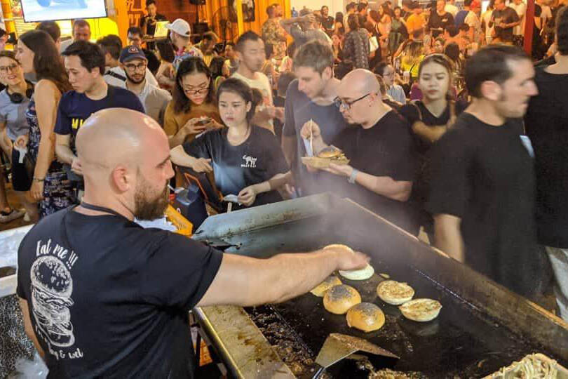 Justyn cooking his classic burgers in Vietnam. Photo courtesy of Justyn Wesley.