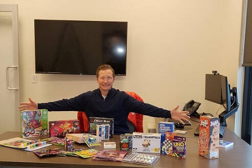 Shawn from the Alitis team showcasing afew of the gifts purchased for families in need of extra support during the holidays last year.