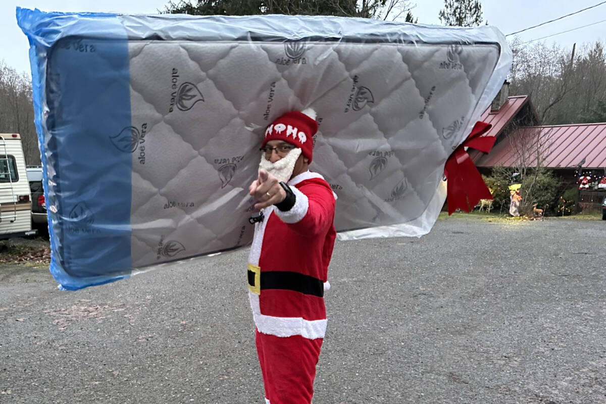 Mark Nagra delivering one of the mattresses for their annual ‘12 days of Christmas Giveaways’.