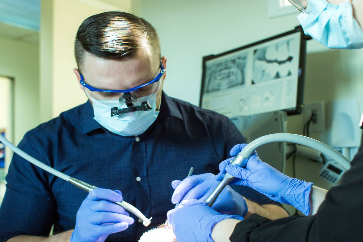 Dr. Chris Goudy, owner of Jubilee Dental in Oak Bay performs a tooth cleaning.