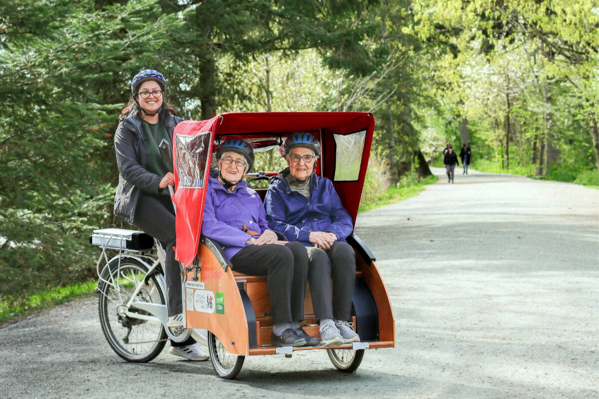 Elim Village residents enjoying a ride along the Vedder River on the trishaw.